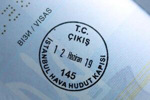 KYIV, UKRAINE - APRIL 20, 2024 Page of foreign passport with visas, Turkiye border stamps, permits to enter countries, concept of traveling around the world, travelers document photo