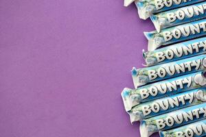 KYIV, UKRAINE - OCTOBER 31, 2023 Bounty chocolate bars with cocoa flavor filling. Bounty chocolate bar is a brand of American Mars Inc photo