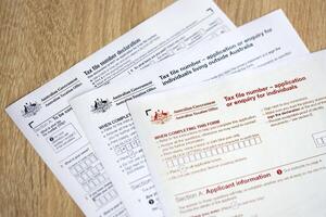 KYIV, UKRAINE - JULY 10, 2024 Australian Tax File Number Application or enquiry for individuals and declaration blank form lies on table of Australian Government taxation office photo