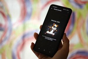 KYIV, UKRAINE - JUNE 26, 2024 Hamster Kombat telegram mini-game in tap 2 earn genre. Tap game on smartphone in hand photo