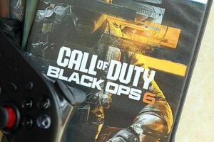 KYIV, UKRAINE - JUNE 26, 2024 Call of Duty Black Ops 6 PS5 game disc box for console gaming. Popular game disc photo