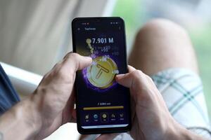 KYIV, UKRAINE - APRIL 20, 2024 Tap Swap telegram bot on smartphone screen. Tap Swap is a viral Telegram based crypto game for earn tokens by managing virtual crypto exchange photo