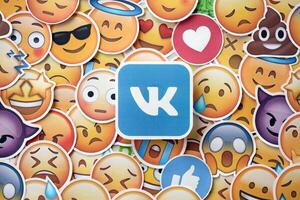 KYIV, UKRAINE - APRIL 20, 2024 VK logo and large set of stickers with Emoji yellow faces. Emoji is a pictogram or smiley embedded in text and used in electronic messages photo