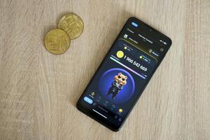 KYIV, UKRAINE - APRIL 20, 2024 Hamster Kombat telegram bot on smartphone screen. Hamster Kombat is a viral Telegram crypto game for earn HMSTR tokens by managing virtual crypto exchange photo