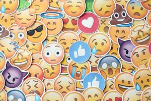 KYIV, UKRAINE - APRIL 20, 2024 Large set of stickers with Emoji yellow faces. Emoji is a pictogram or smiley embedded in text and used in electronic messages photo