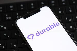 KYIV, UKRAINE - MARCH 17, 2024 Durable logo on iPhone display screen and MacBook keyboard photo