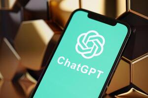 KYIV, UKRAINE - MARCH 17, 2024 ChatGPT logo on iPhone display screen with background of artificial intelligence futuristic image photo