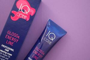 KYIV, UKRAINE - OCTOBER 31, 2023 Tube of IQ Code Gloss and Energy Line colorizer cream for hair photo