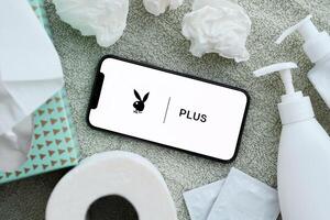 KYIV, UKRAINE - JANUARY 23, 2024 PlayboyPlus adult content website logo on display of iPhone 12 Pro photo