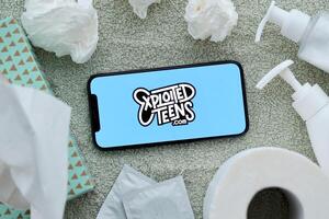 KYIV, UKRAINE - JANUARY 23, 2024 ExploitedTeens adult content website logo on display of iPhone 12 Pro photo