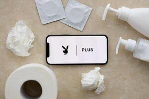 KYIV, UKRAINE - JANUARY 23, 2024 PlayboyPlus adult content website logo on display of iPhone 12 Pro photo