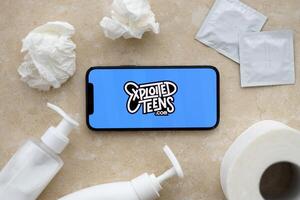 KYIV, UKRAINE - JANUARY 23, 2024 ExploitedTeens adult content website logo on display of iPhone 12 Pro photo