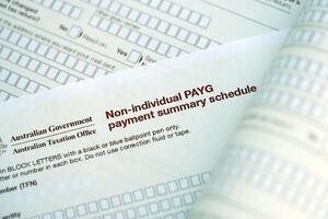 KYIV, UKRAINE - JULY 10, 2024 Australian Non-Individual PAYG payment summary schedule blank form lies on table of Australian Government taxation office photo
