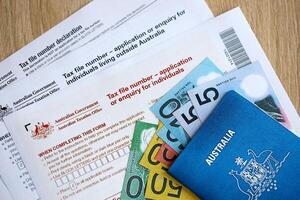 KYIV, UKRAINE - JULY 10, 2024 Australian Tax File Number Application or enquiry for individuals and declaration blank form lies on table of Australian Government taxation office photo