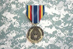 KYIV, UKRAINE - JULY 10, 2024 Global War on Terrorism Service medal. United States military award medal with ribbon and pin. Handmade paper theater props photo