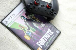 KYIV, UKRAINE - JUNE 26, 2024 Fortnite Last Laugh bundle PS5 game disc box for console gaming. Popular game disc photo