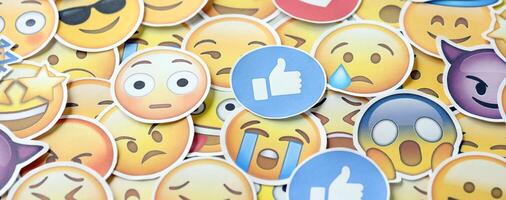 KYIV, UKRAINE - APRIL 20, 2024 Large set of stickers with Emoji yellow faces. Emoji is a pictogram or smiley embedded in text and used in electronic messages photo