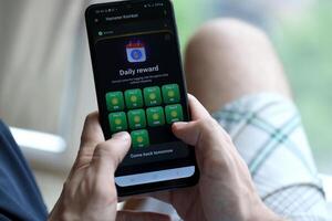 KYIV, UKRAINE - APRIL 20, 2024 Hamster Kombat telegram bot on smartphone screen. Hamster Kombat is a viral Telegram crypto game for earn HMSTR tokens by managing virtual crypto exchange photo
