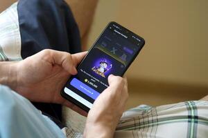 KYIV, UKRAINE - APRIL 20, 2024 Hamster Kombat telegram bot on smartphone screen. Hamster Kombat is a viral Telegram crypto game for earn HMSTR tokens by managing virtual crypto exchange photo