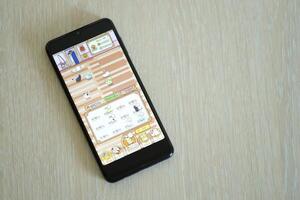 KYIV, UKRAINE - APRIL 20, 2024 Catizen telegram bot on smartphone screen. Catizen is a viral Telegram based crypto game for earn tokens by managing virtual crypto exchange photo