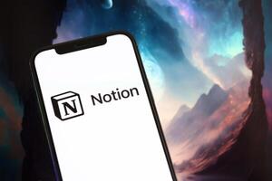 KYIV, UKRAINE - MARCH 17, 2024 Notion logo on iPhone display screen with background of artificial intelligence futuristic image photo