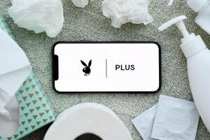 KYIV, UKRAINE - JANUARY 23, 2024 PlayboyPlus adult content website logo on display of iPhone 12 Pro photo