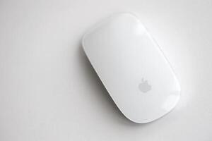 KYIV, UKRAINE - NOVEMBER 27, 2023 Apple Magic Mouse 3rd generation lies on white background photo