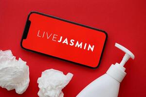KYIV, UKRAINE - JANUARY 23, 2024 LiveJasmin adult content website logo on display of iPhone 12 Pro photo