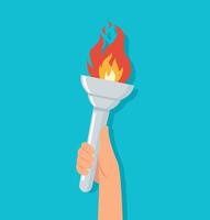 hand holding torch with burning flame vector