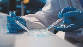 Close-up of a scientist's hands holding a flask with pink liquid in a lab. video