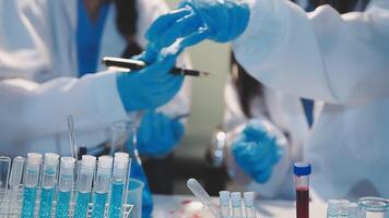 Close-up of a scientist's hands holding a flask with pink liquid in a lab. video