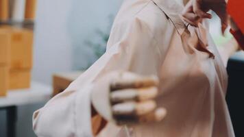 Designer concept.The dressmaker is designing an evening dress in the room.Asian clothing designers are measuring sample sizes to prepare evening gowns for important customer orders video