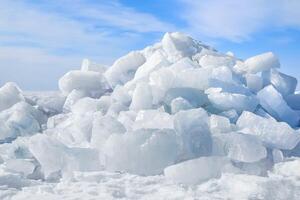 Barrow of ice blocks sparkling in the sun against a blue sky photo