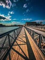 Pedestrian bridge across the bay in Stockholm, Sweden, Scandinavian architecture and beautiful shade from the structure on a sunny day photo
