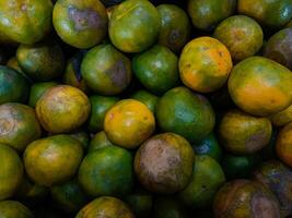 Stacks of orange fruits that look very fresh with a tasteful color at market outdoor photo
