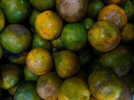 Stacks of orange fruits that look very fresh with a tasteful color at market outdoor photo