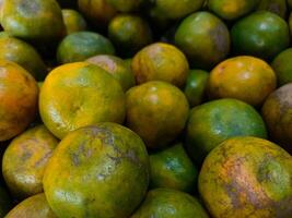 Stacks of orange fruits that look very fresh with a tasteful color at market outdoor photo