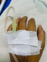 Asian man in hospital with intravenous saline. hand is being infused, infected with the virus, are lying and being treated in beds in hospitals. photo