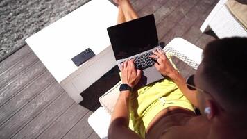 Man laptop sea. Working remotely on seashore. Happy successful man, male freelancer working on laptop on beach, relieves stress from work to restore life balance. Freelance, remote work on vacation video