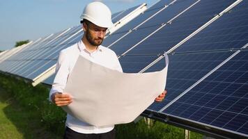 An engineer checks the documentation of the solar station video