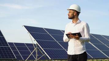 Engineer using tablet to test solar panels. High solar energy usage video