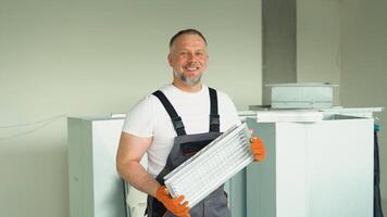 Worker holding air filter for installing in the commercial building or office ventilation system. Purity of the air concept video