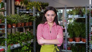 Young woman florist happy smile arms crossed, look camera, enjoy open flower shop work at home office workspace video