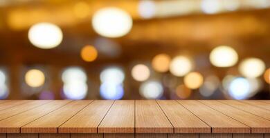 Empty wooden table top with lights bokeh on blur restaurant background. photo