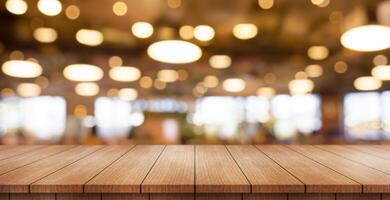 Empty wooden table top with lights bokeh on blur restaurant background. photo