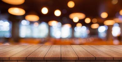 Empty wooden table top with lights bokeh on blur restaurant background. photo