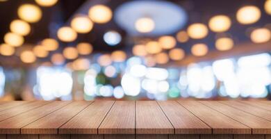 Empty wooden table top with lights bokeh on blur restaurant background. photo