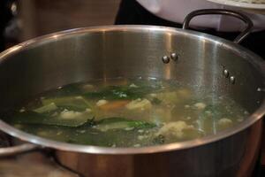 delicious and tasty vegetable soup in a pot on top photo