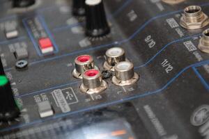 row of silver gold audio input connectors, on a professional audio mixing console or desk photo