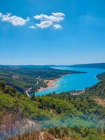 magnificent lake of Sainte-Croix with clear crystalline waters, incredible view of blue waters where you can sunbathe, do sports such as canoeing, lake surrounded by nature, trees, rocks. Sunny day photo